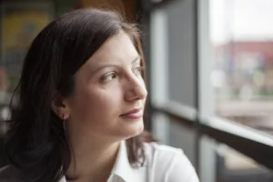 Woman looking out a window - Endometrial Ablation graphic