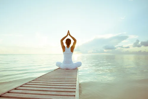 Confident woman doing yoga after labiaplasty surgery.