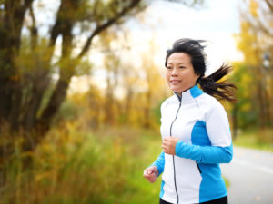 Woman jogging outside during fall 
