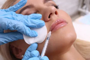beautiful girl getting lip filler in the doctors office