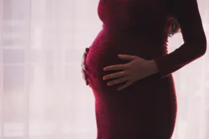 woman about to give birth to a child while contemplating vaginoplasty
