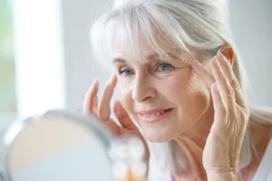 Woman contemplating getting a face lift from facial volume loss