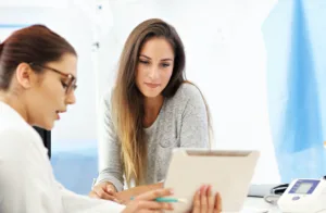 Woman discussing her options between labia puffing and labiaplasty with her doctor