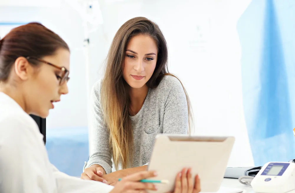 Woman discussing her options between labia puffing and labiaplasty with her doctor