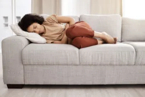 Woman struggling with pain in the abdominal area.