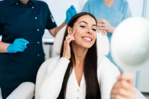 woman looking at her face after getting dermal fillers and a fat transfer at the medspa in Los Angeles