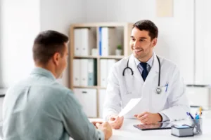 A man receiving post-op instructions from his doctor.