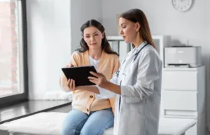 A doctor going over aftercare tips with her patient.