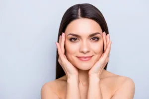 A woman showing off her symmetrical face after receiving Botox.