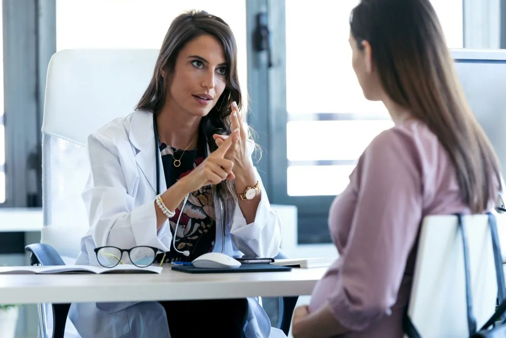 A doctor discussing pre-op care and factors to consider before the patients surgery.