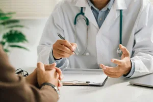 A man discussing treatment plans with his primary care physician.