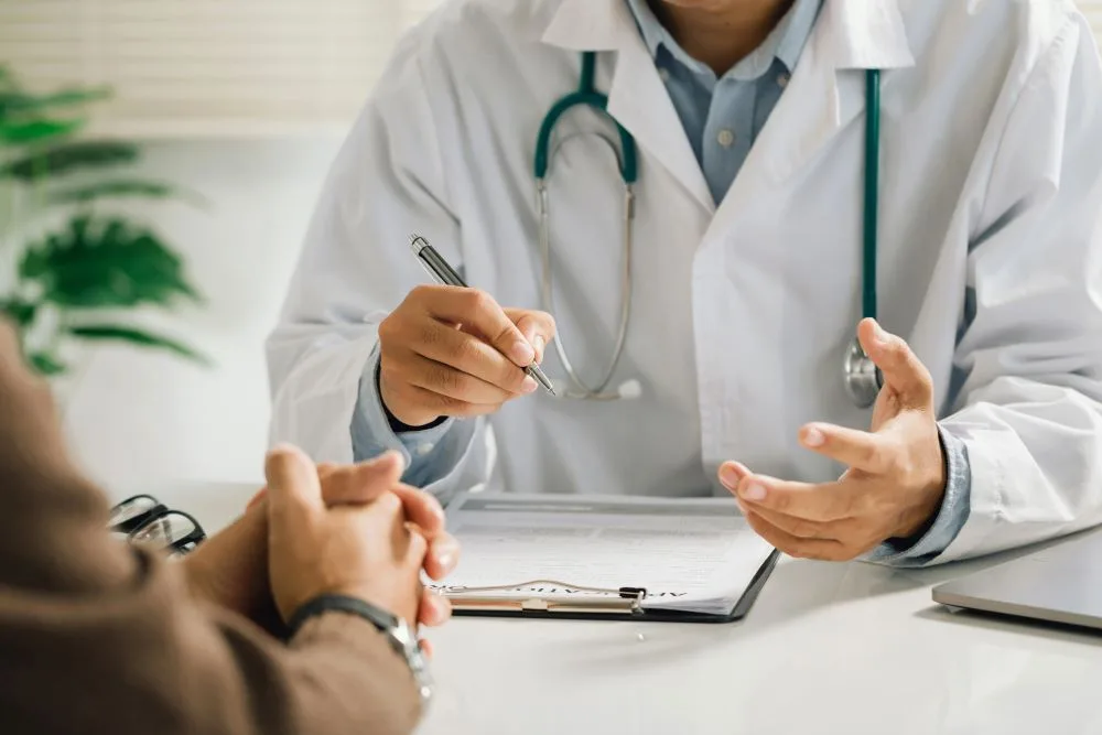 A man discussing treatment plans with his primary care physician.