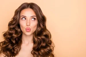 A woman with lip filler puckering her lips.
