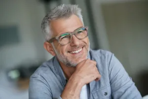 A middle-aged man smiling confidently.