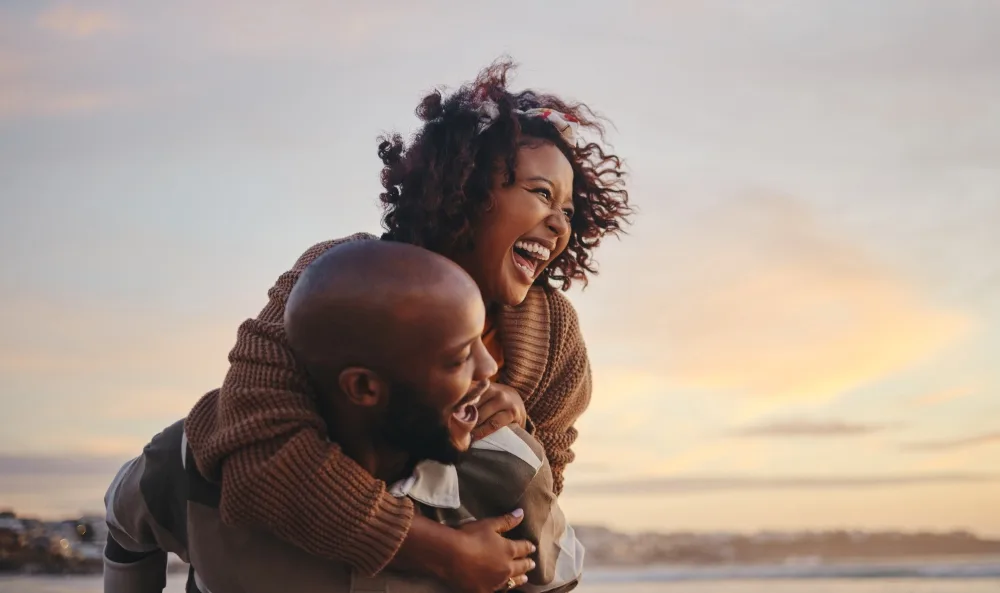 A happy couple on a beautiful day at the beach.