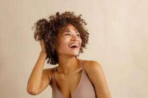 A woman smiling and feeling confident in herself.