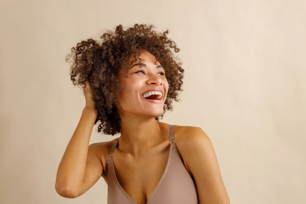 A woman smiling and feeling confident in herself.