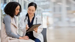 Woman patient and tablet for consulting with results, medical info and to discuss woman healthcare.