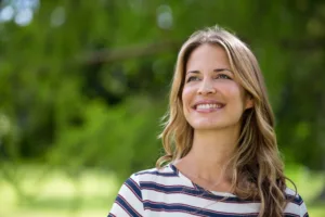 A smiling woman looking up with positivity.