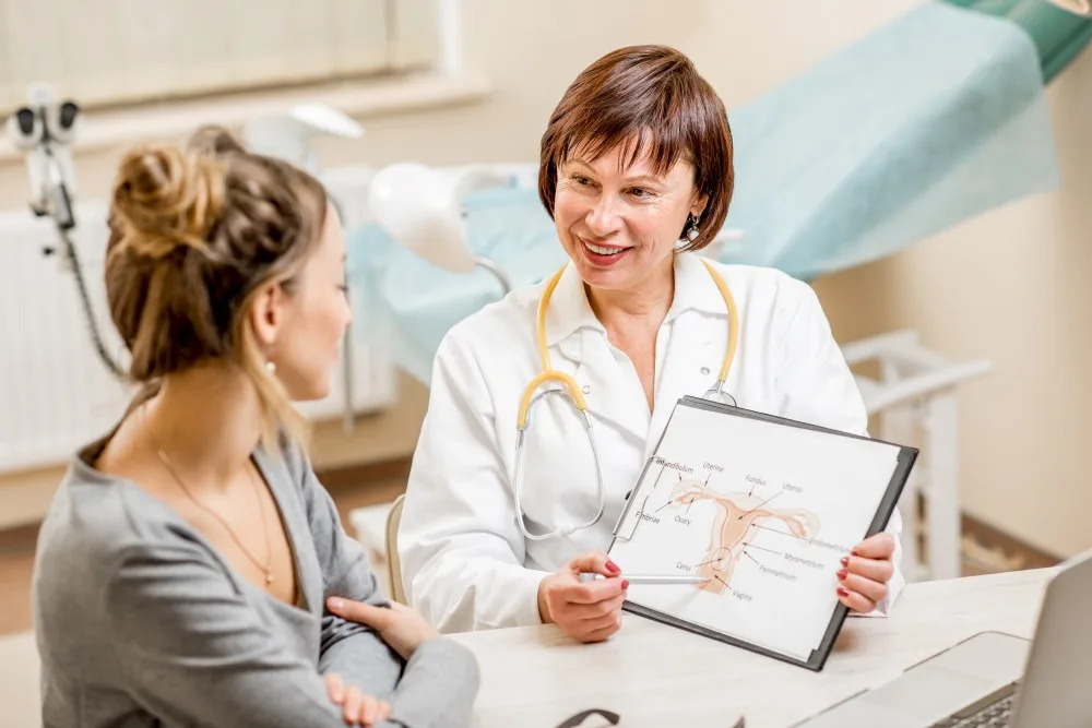 A woman speaking with her gynecologist about her cosmetic surgery.