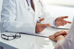 A male doctor consulting his female patient of potential side effects and risks of a procedure.