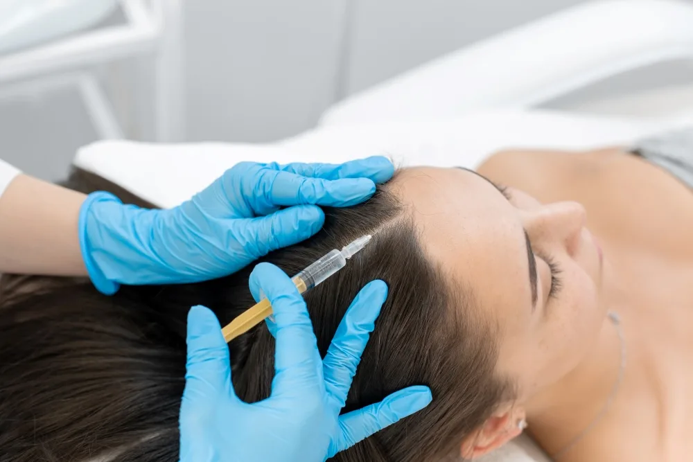 Beautician injections for healthy hair growth. A young girl is undergoing a course of spa treatments in the office of a beautician.