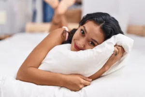 A woman smiling and feeling comfortable and confident in herself.